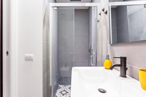 a bathroom with a sink and a shower at Easylife - Milano - D'Annunzio - Navigli in Milan