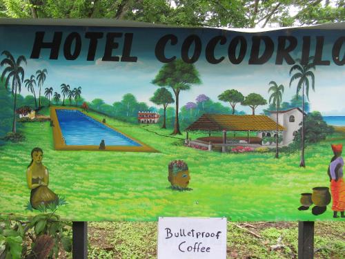 a sign for a hotel coober pedy with a pool at spirit of jungle lodge in Sámara
