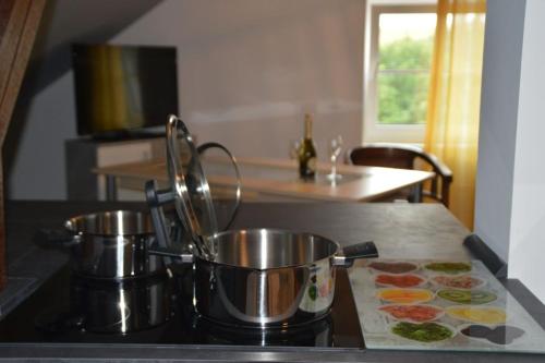 2 ollas y sartenes en una cocina en Gardenia 2, en Stadtlauringen