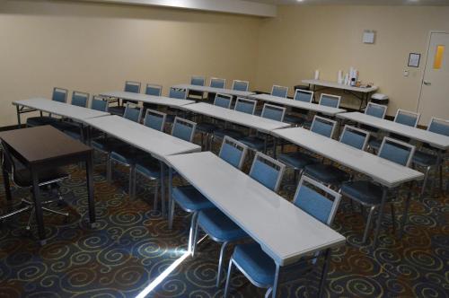 an empty classroom with rows of tables and chairs at Holiday Inn Express Yorkton East by IHG in Yorkton