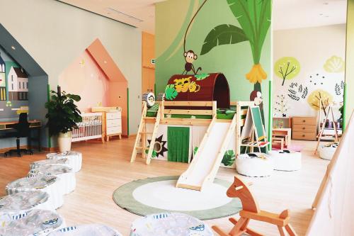 a childrens room with a play area with chairs and toys at Holiday Inn Wuxi Taihu New City by IHG in Wuxi