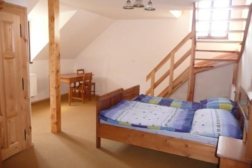 a bedroom with a bunk bed and a staircase at Statek Chmelovice in Chmelovice