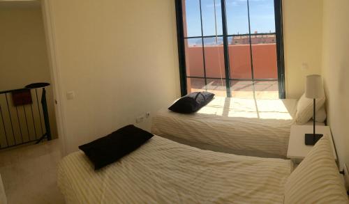 A bed or beds in a room at PENTHOUSE BLUELINE IN SIERRA CORTINA