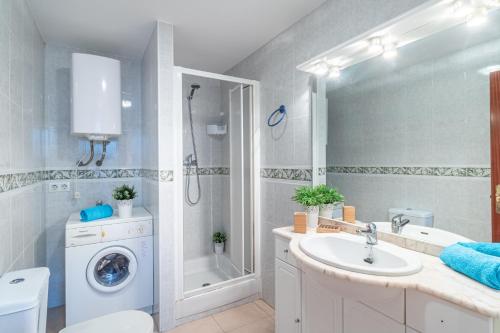 een badkamer met een wasmachine en een wastafel bij Empurialola -Apartamento en primera linea de ma vistas al mar -164 in Empuriabrava