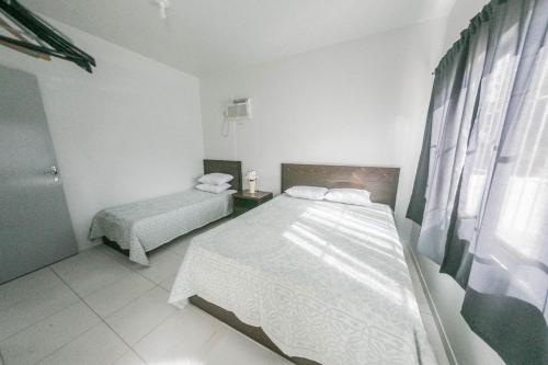 Tempat tidur dalam kamar di DS1 - CASA COM PISCINA PRIVATIVA - 2 dorm - PRAIA DE MEIA PRAIA - BRUNO KLEMTZ