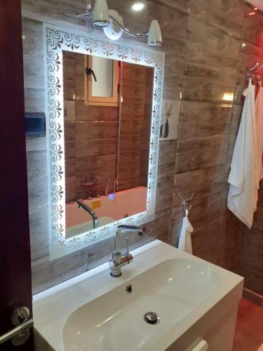 a bathroom with a sink and a mirror at Elmoapart in Agadir