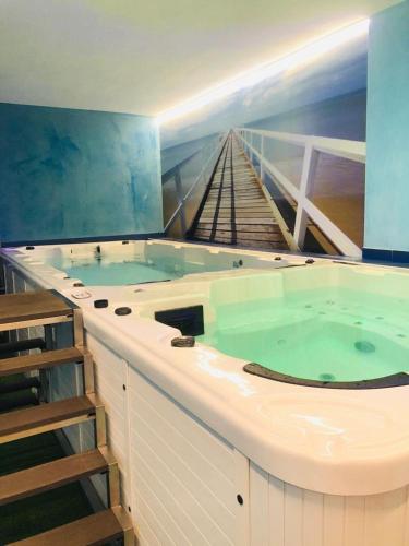 a large hot tub with a staircase in a room at villa oltremare resort in Bagheria