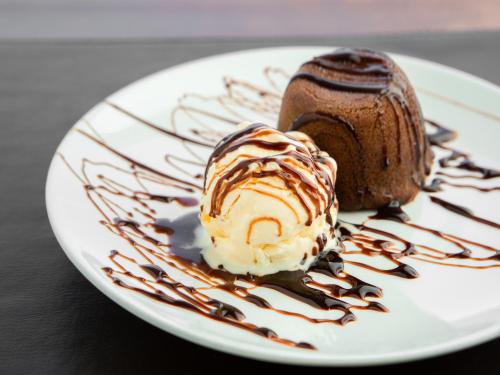 a piece of chocolate cake and ice cream on a plate at Vinhedo Plaza Hotel in Vinhedo
