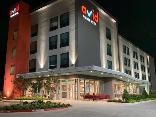 a building with a sign on the side of it at Avid hotels - Oklahoma City Airport by IHG in Oklahoma City