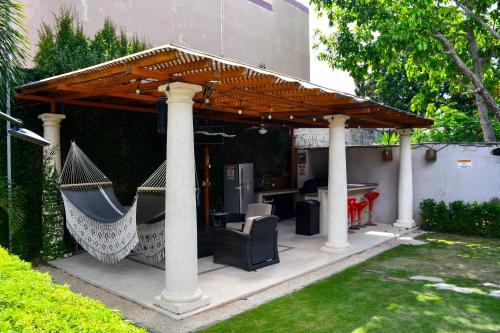 a gazebo with two chairs and a hammock at 11B Jaco Sol Quadplex in Jacó