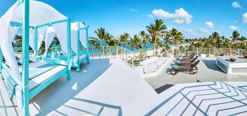 a deck of a cruise ship with palm trees at Dream Punta Cana Beachfront Apartment - 4-Bedroom Penthouse with Rooftop BBQ & Ocean Views in Punta Cana