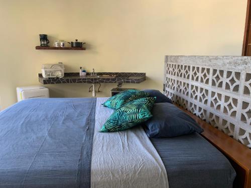 a bed with two pillows on it in a room at Playa Bruja Zicatela in Puerto Escondido