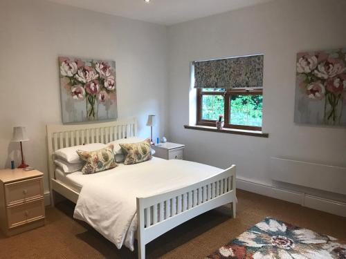 a bedroom with a white bed and a window at Grey Oak in Newark-on-Trent