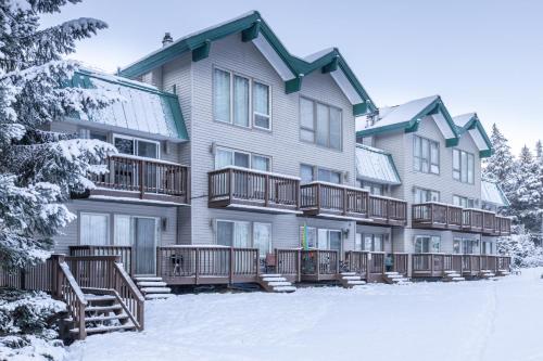 a large apartment building with decks in the snow at Alyeska North #400 in Girdwood