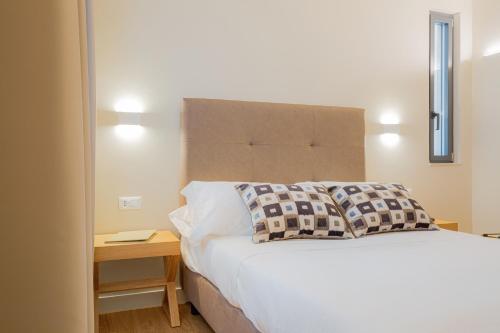 a bedroom with a bed and a table with a mirror at Hotel Politeama in Palermo