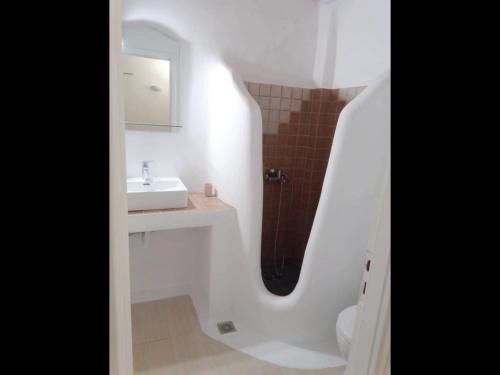 a bathroom with a sink and a mirror at Mykonos efis maisonette in Mikonos