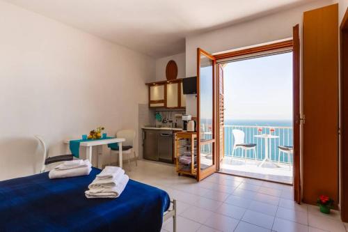 a bedroom with a blue bed and a view of the ocean at Casa mare blu in Amalfi