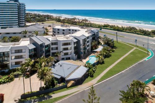 an aerial view of a resort with the beach at Mylos Holiday Apartments in Alexandra Headland