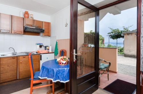 a kitchen with a table with a blue table cloth at Apartments Ilinka in Lovran