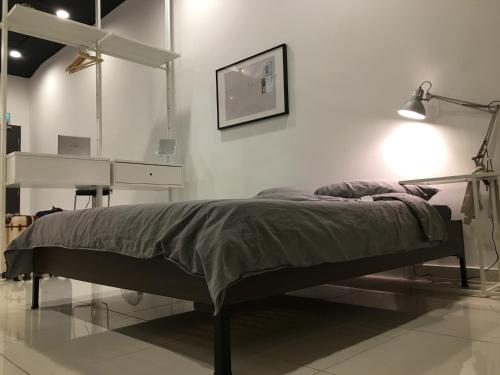 a bedroom with a bed and a desk in a room at 7 mins KLCC next to Hospital Gleneagle in Kuala Lumpur