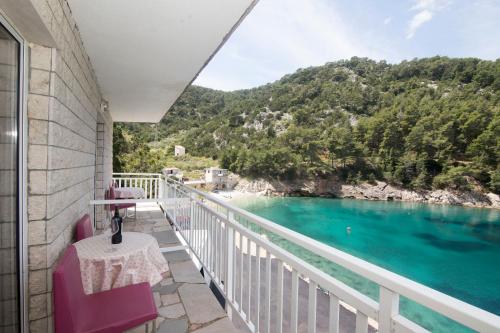 a balcony with a view of the water at Apartments Ante in Bogomolje