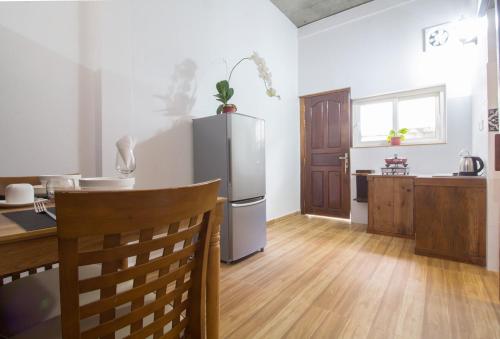 a kitchen with a refrigerator and a wooden floor at ANGKOR DINO HOME in Siem Reap