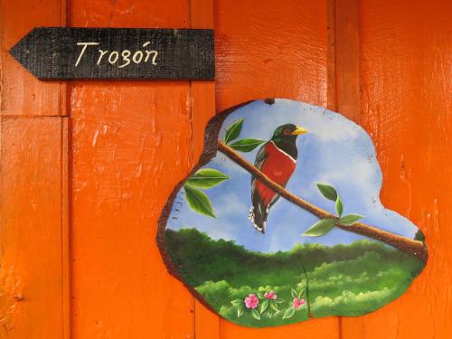 a painting of a bird perched on a tree branch at Reserva La Rivera in Salento
