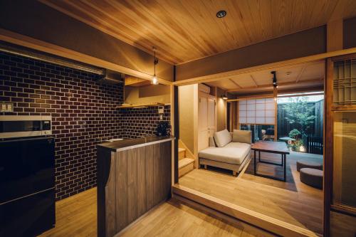 a kitchen and living room with a couch and a chair at Someno House Kyoto Dog Friendly in Kyoto