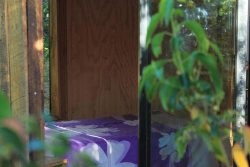 a bedroom with a bed with a purple comforter at Casa domo San Fabián de Alico in San Fabián de Alico