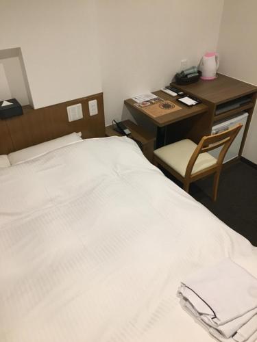 ナゴヤエキ　アクセスホテルにあるベッド