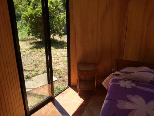 a room with a bed and a sliding glass door at Casa domo San Fabián de Alico in San Fabián de Alico
