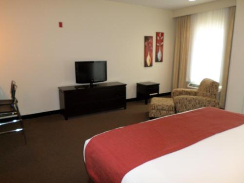 a hotel room with a bed and a flat screen tv at Berlin Grande Hotel in Berlin