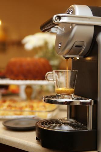 a coffee maker is making a cup of coffee at Hotel Expocity Istanbul in Avcılar