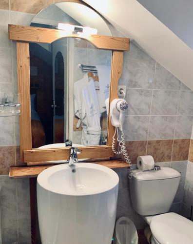 a bathroom with a sink and a toilet and a mirror at Coeur des Neiges in Saint-Gervais-les-Bains