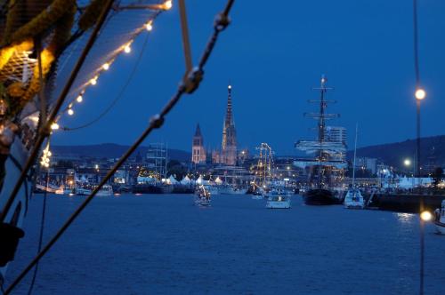 a view of a harbor with boats in the water at night at Holiday Inn Express - Rouen Centre - Rive Gauche by IHG in Rouen