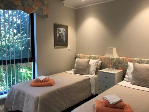 a bedroom with two beds and a window at Alfred Cove Short Stay in Perth