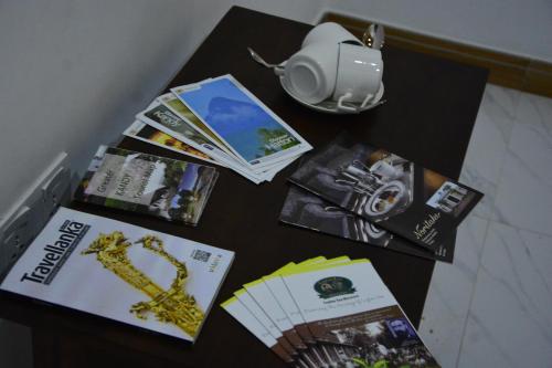 a table with books and magazines on top of it at Seven Luck Palace in Kandy