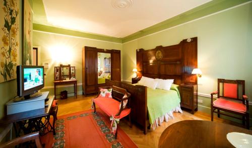 a hotel room with a bed and a television at Palazzo Dalla Rosa Prati in Parma