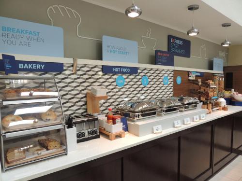 a bakery counter with a lot of food on it at Holiday Inn Express Trussville by IHG in Trussville