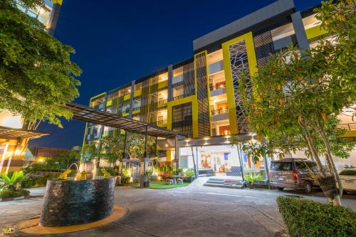 a building with a car parked in front of it at SB Living Place Hotel Phuket Town in Phuket