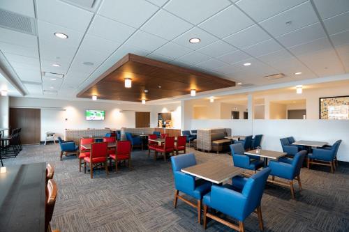 a room filled with tables, chairs, and tables at Holiday Inn Express - Lethbridge Southeast, an IHG Hotel in Lethbridge