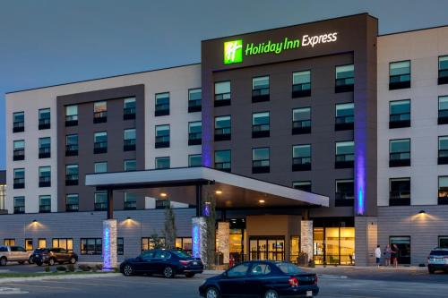 a building with cars parked in front of it at Holiday Inn Express - Lethbridge Southeast by IHG in Lethbridge