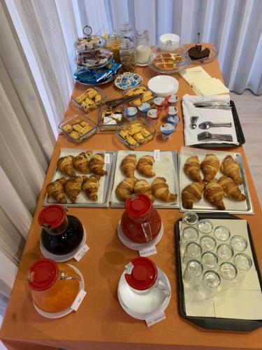 a table filled with different types of pastries and desserts at HOTEL DOZZA in Dozza