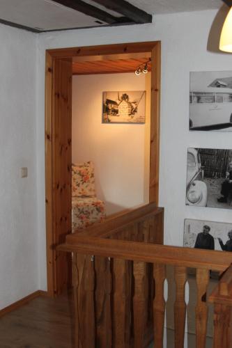 a room with a wooden staircase with a couch in it at Ferienhaus Eifelperle in Blankenheim