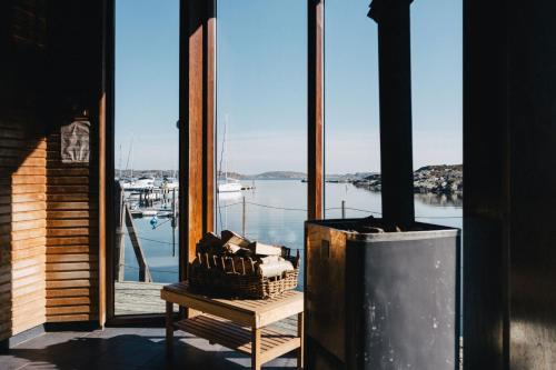 a room with a fireplace and a view of a marina at Björholmen Hotell & Restaurang in Björholmen