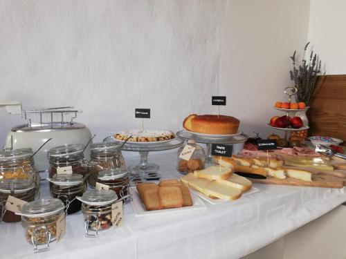 a buffet of cheese and other foods on a table at Cà Maìna in Santa Sofia