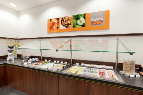 a display case in a restaurant with food at Holiday Inn Express Augsburg by IHG in Augsburg