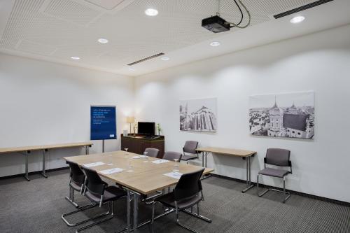 a conference room with a table and chairs at Holiday Inn Express Augsburg by IHG in Augsburg