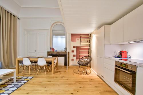 a kitchen and dining room with a table and chairs at 21Royale in Lyon