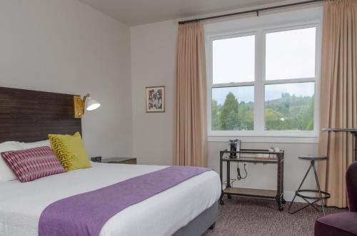 a hotel room with a bed and a window at The Dundee - A Trace Hotel in Dundee
